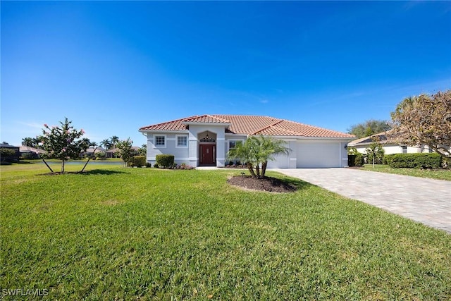 mediterranean / spanish-style home featuring a garage and a front yard