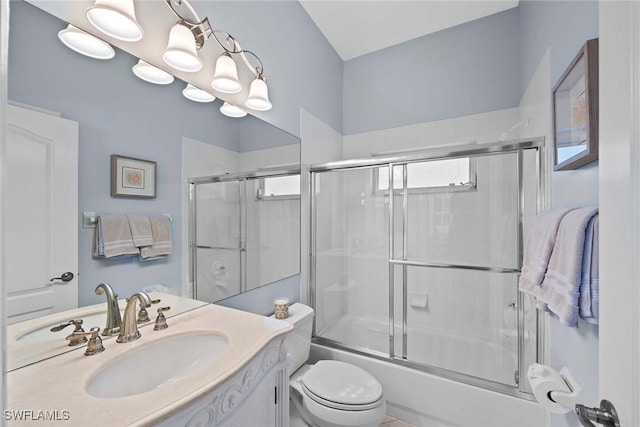 full bathroom with vanity, combined bath / shower with glass door, and toilet