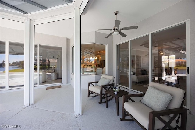 sunroom featuring ceiling fan