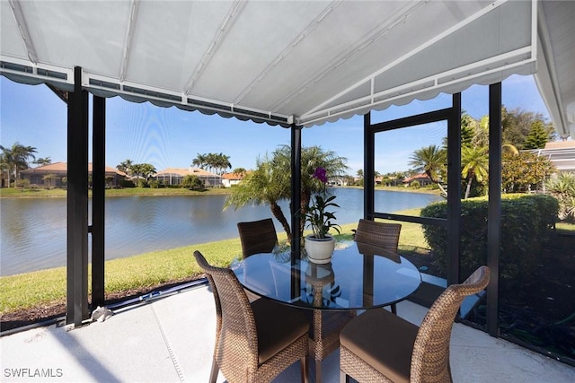 sunroom / solarium featuring a water view