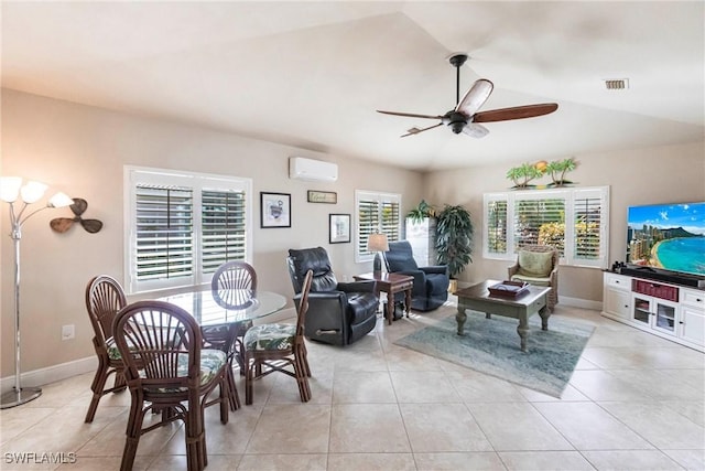 tiled dining space featuring vaulted ceiling, ceiling fan, and a wall unit AC