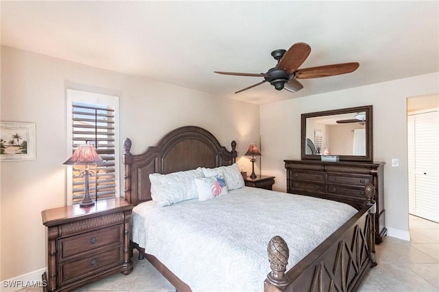 tiled bedroom featuring ceiling fan