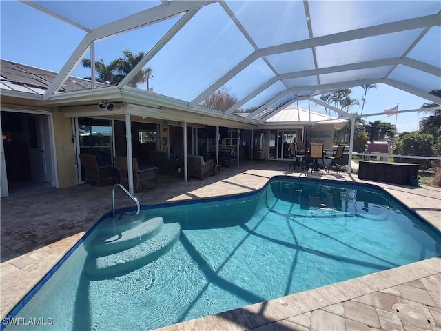 view of pool with a patio and a lanai