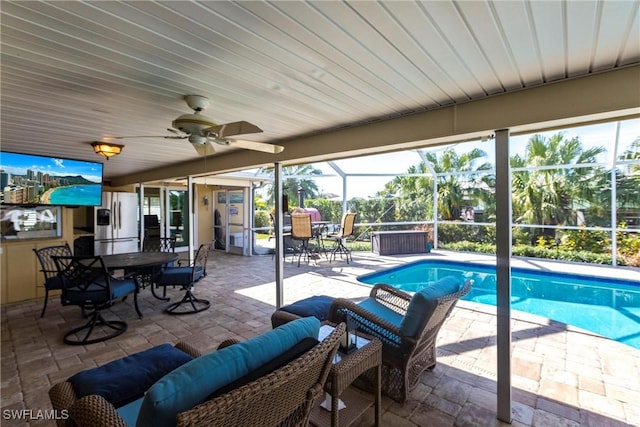 view of swimming pool featuring an outdoor hangout area, a lanai, a patio area, and ceiling fan