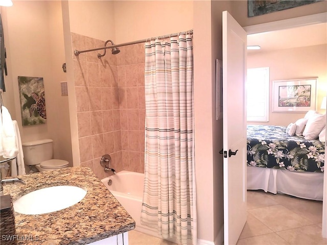 full bathroom featuring tile patterned flooring, sink, toilet, and shower / bath combo with shower curtain