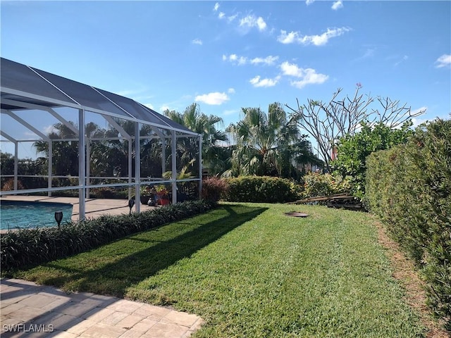 view of yard with a patio area and glass enclosure