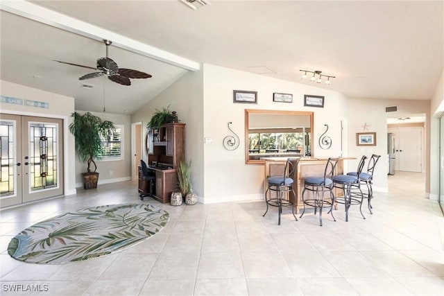 interior space featuring lofted ceiling, light tile patterned floors, ceiling fan, and french doors