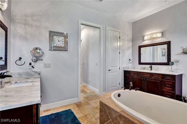 bathroom featuring vanity and a relaxing tiled tub