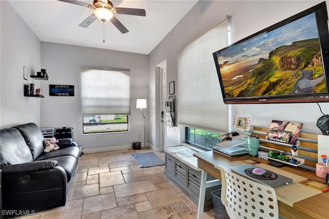 interior space with ceiling fan