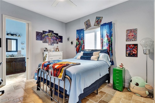 bedroom featuring sink, ceiling fan, and ensuite bathroom