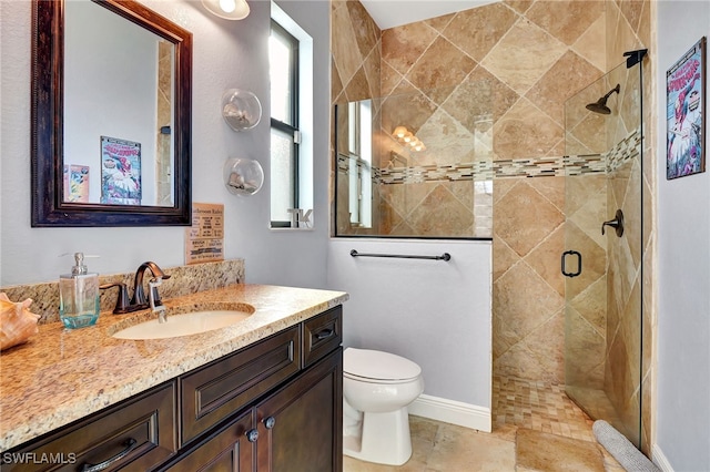 bathroom with vanity, toilet, and an enclosed shower