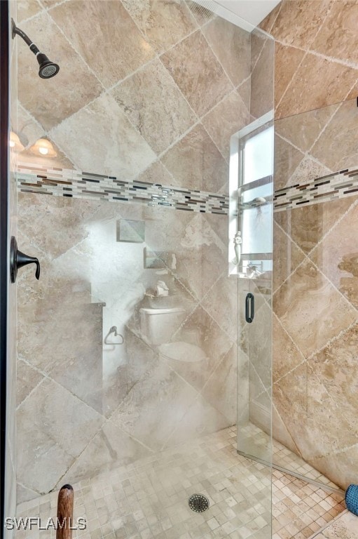 bathroom with a shower with shower door