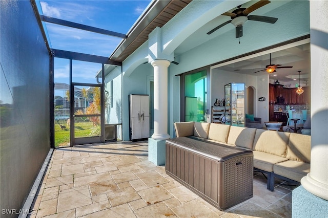 view of patio with a lanai, outdoor lounge area, and ceiling fan