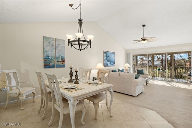 tiled dining room featuring ceiling fan and vaulted ceiling