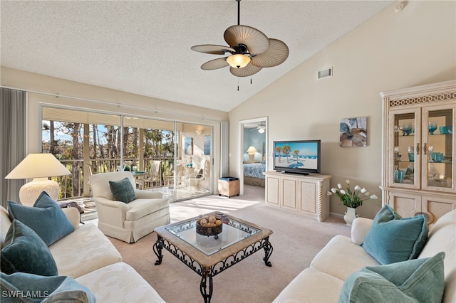 carpeted living room featuring ceiling fan, high vaulted ceiling, and a textured ceiling