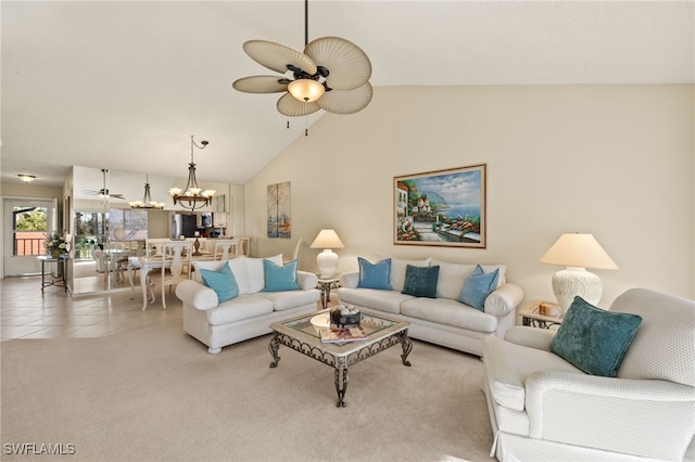 carpeted living room with ceiling fan with notable chandelier and high vaulted ceiling