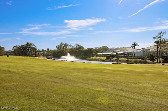 surrounding community featuring a lawn and a water view