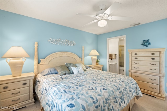 carpeted bedroom featuring connected bathroom and ceiling fan