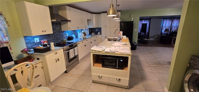 kitchen with decorative light fixtures, washer / clothes dryer, white cabinets, black appliances, and wall chimney range hood