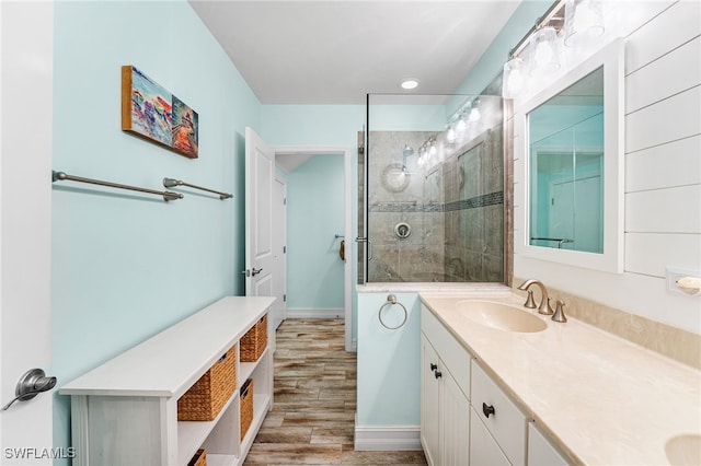 bathroom with vanity, hardwood / wood-style floors, and a tile shower