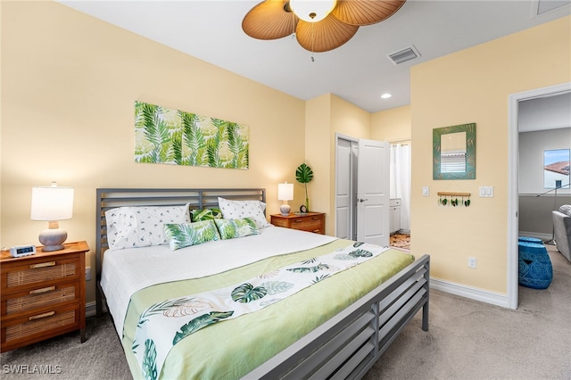 carpeted bedroom featuring ceiling fan and a closet