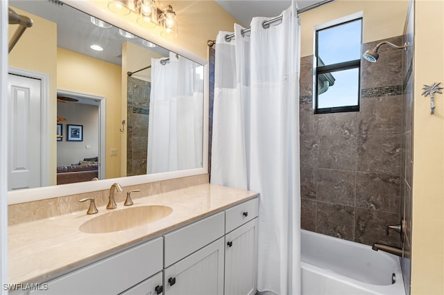 bathroom featuring vanity and shower / bathtub combination with curtain