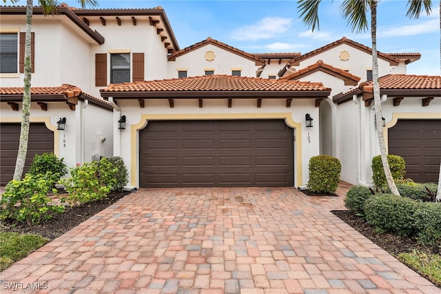 mediterranean / spanish home with a garage