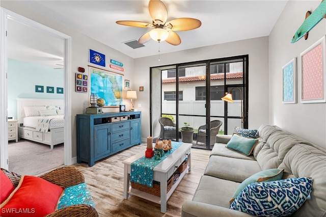 living room featuring ceiling fan and light wood-type flooring