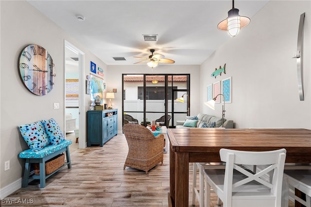 dining area with ceiling fan and light hardwood / wood-style flooring