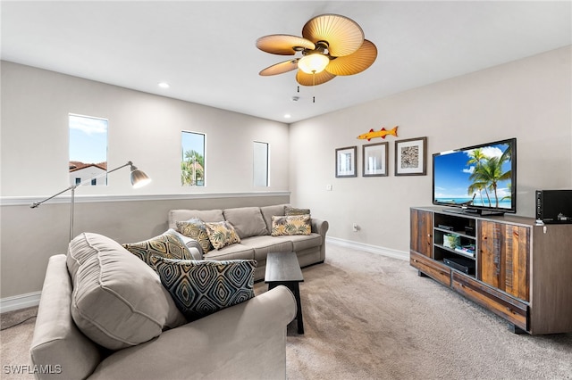 carpeted living room with ceiling fan