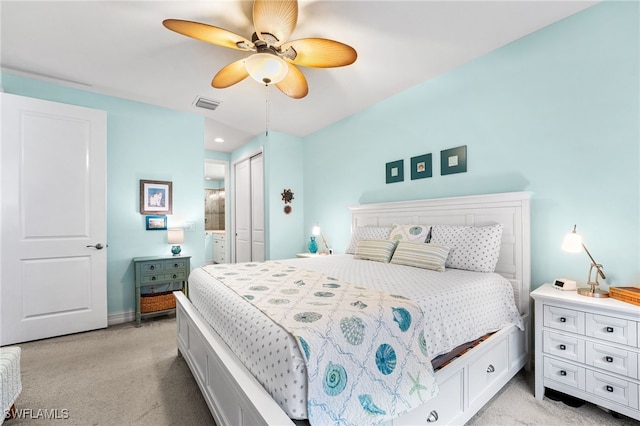 bedroom featuring ceiling fan, a closet, and light carpet