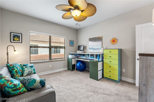 carpeted office space with ceiling fan