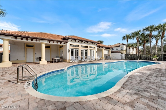 view of swimming pool featuring a patio area and french doors