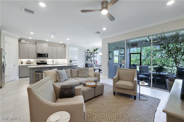 living room with visible vents, ornamental molding, and recessed lighting