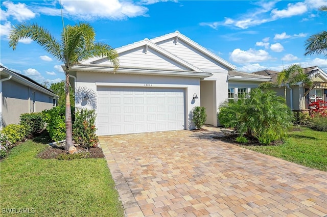 ranch-style home with a garage and a front yard