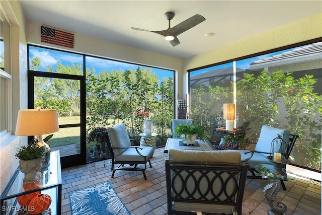 sunroom with visible vents and ceiling fan