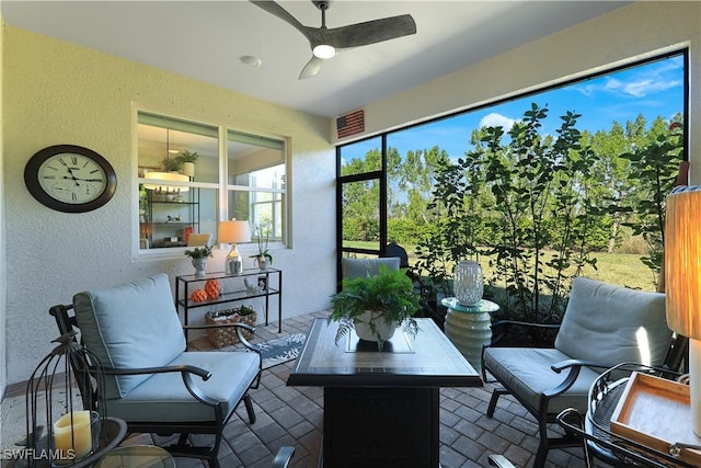 sunroom / solarium with a ceiling fan