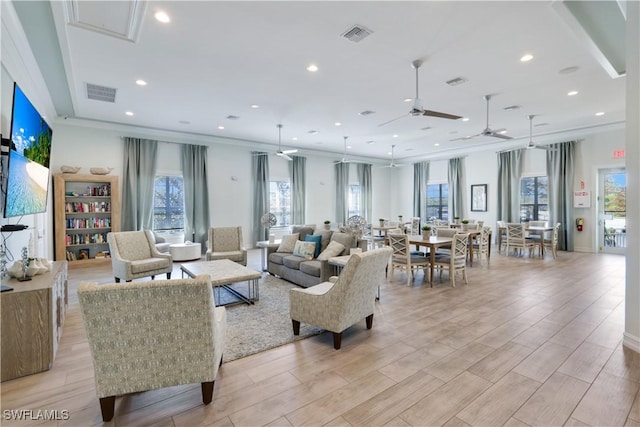 living room featuring ornamental molding, wood tiled floor, visible vents, and recessed lighting