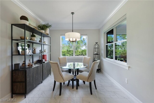 dining room featuring ornamental molding, marble finish floor, and baseboards