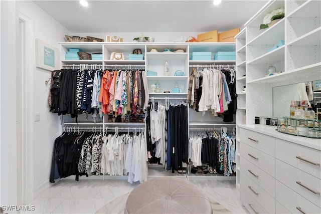 spacious closet featuring marble finish floor