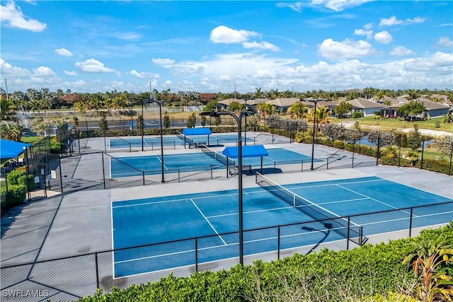 view of sport court with a residential view and fence