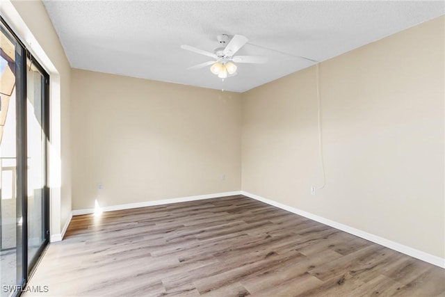 spare room with ceiling fan, a textured ceiling, and light wood-type flooring