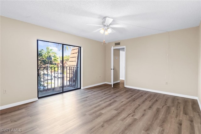 unfurnished room with hardwood / wood-style flooring, a textured ceiling, and ceiling fan