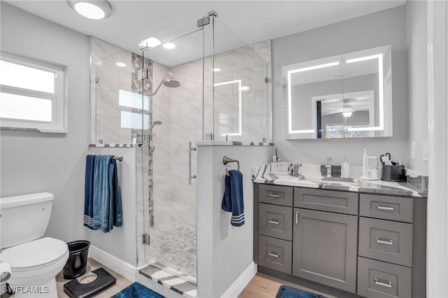 bathroom with walk in shower, vanity, toilet, and hardwood / wood-style flooring