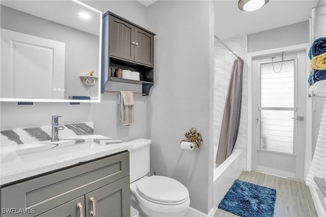 full bathroom featuring vanity, wood-type flooring, shower / tub combo, and toilet