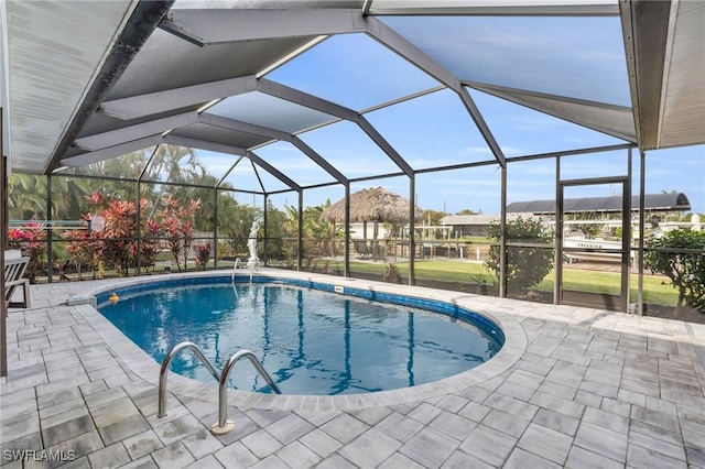 view of swimming pool with a patio and glass enclosure