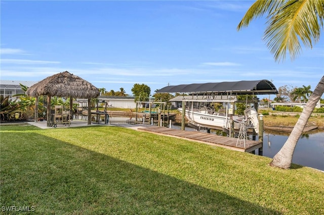 view of dock with a gazebo, a water view, and a yard