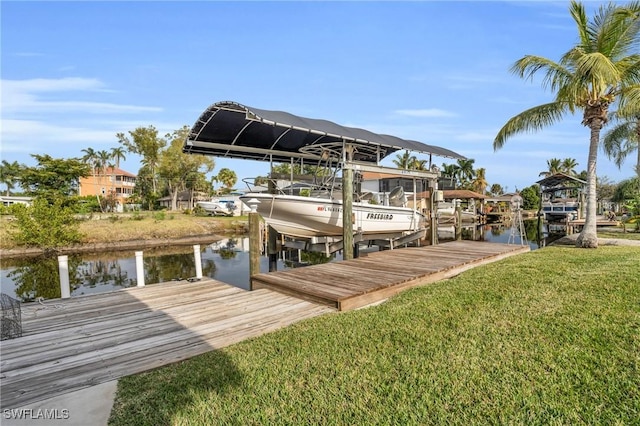 dock area with a yard and a water view