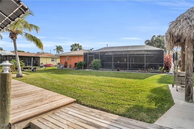 view of yard featuring a lanai and a deck