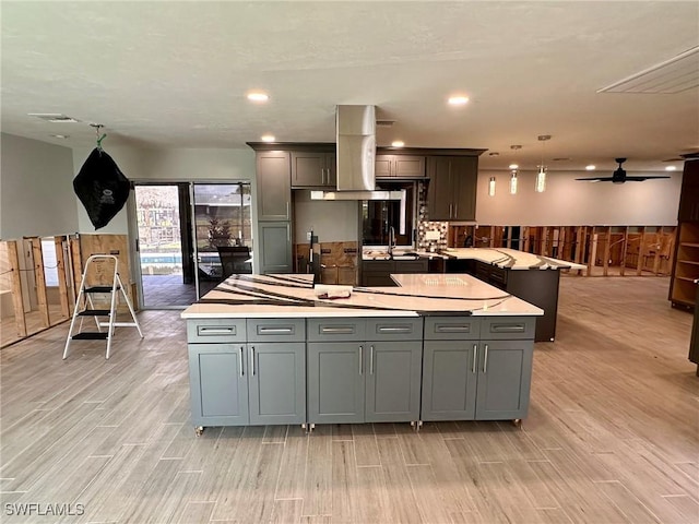 kitchen with hanging light fixtures, gray cabinets, and a center island